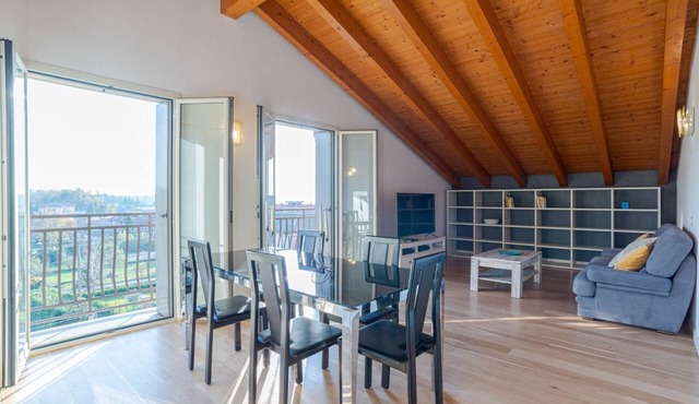 GuestHost - Travel with your family and friends and explore lakes and mountains near Como!This large attic, with two bedrooms, two bathrooms, open space kitchen with island, large living room, terraces and patio for relaxing, is located on the road that